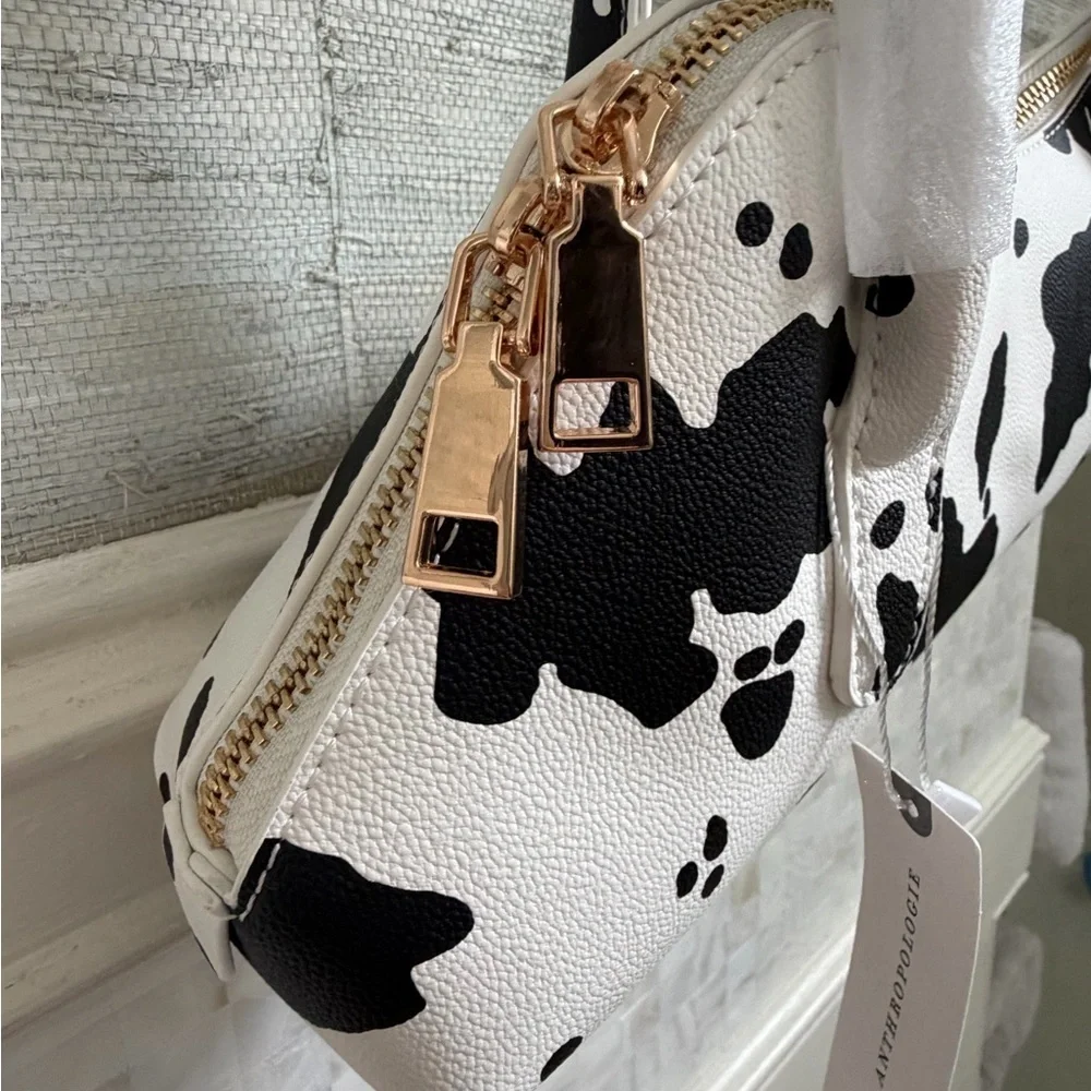 NWT new Anthropologie melie bianco east west shoulder bag cow print black white
